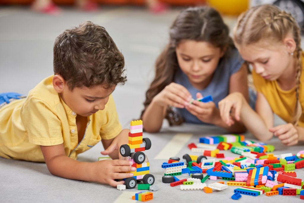 Children playing together in the classroom in kindergarten.